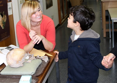 Adrienne Frie, UW-Milwaukee, explains nutrition and the human body to a young visitor. Photo A. Rivera.