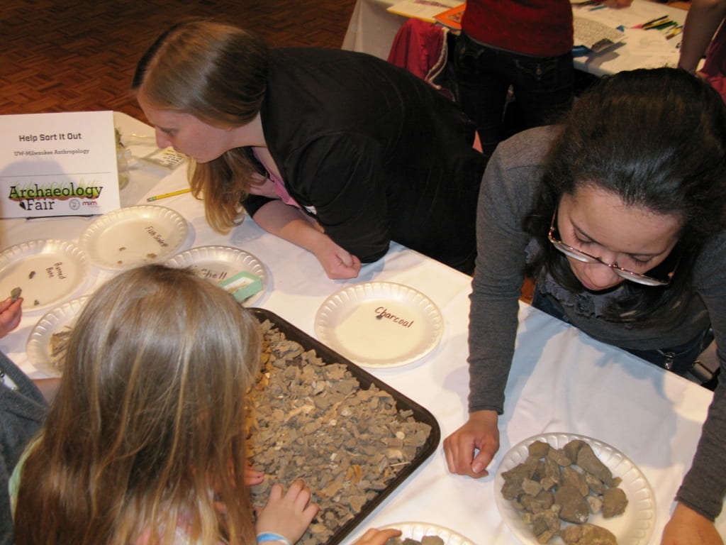 Kids help sort out artifacts from flotation